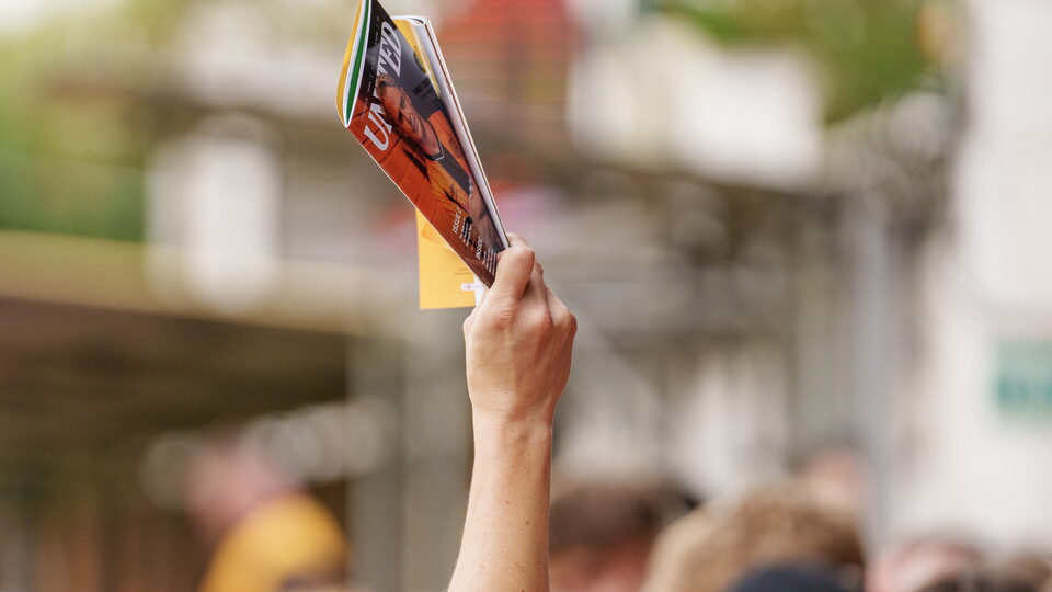 Matchday Programme held aloft