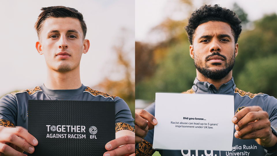 Players hold Together Against Racism cards