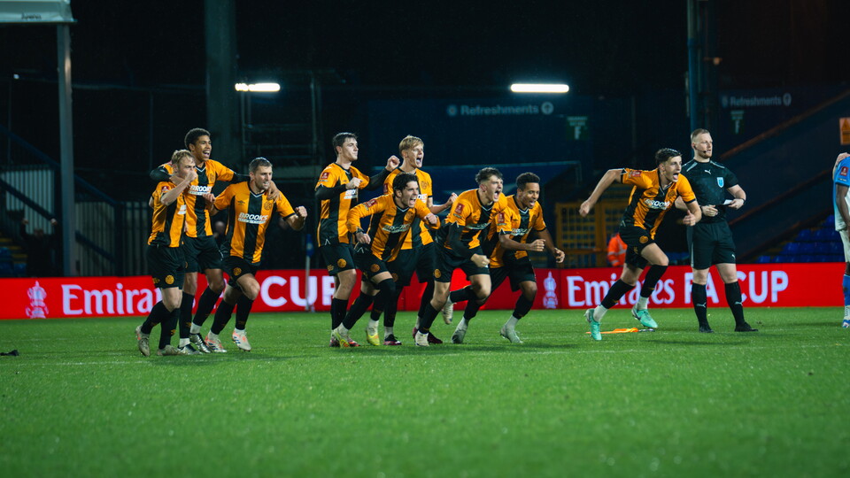 Cambridge United players celebrate a penalty shoot-out win