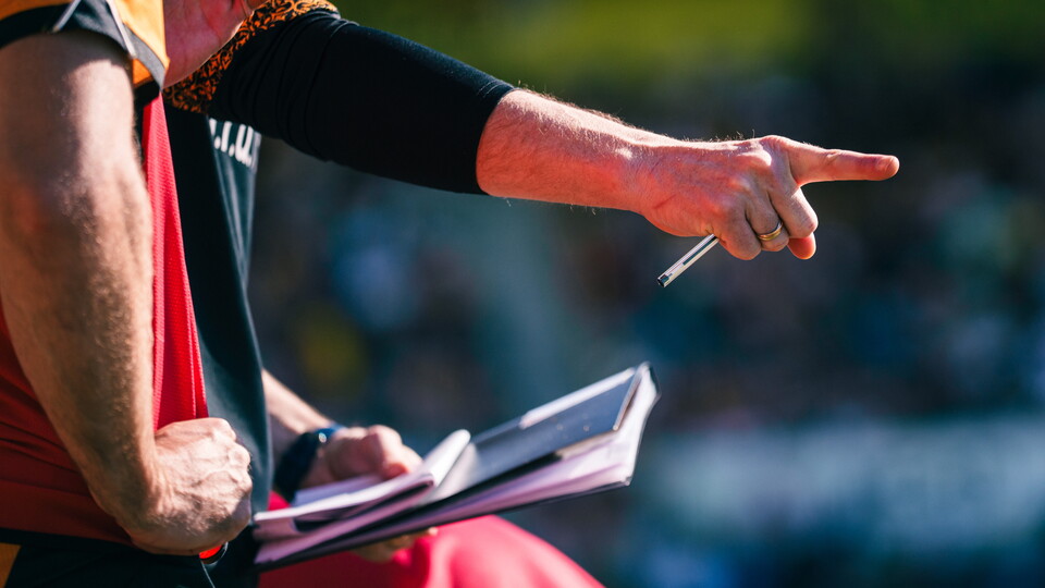 A close up of a substitute preparing to be brought on
