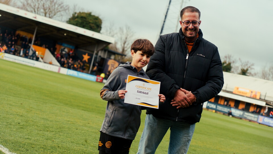 A community hero receives his certificate