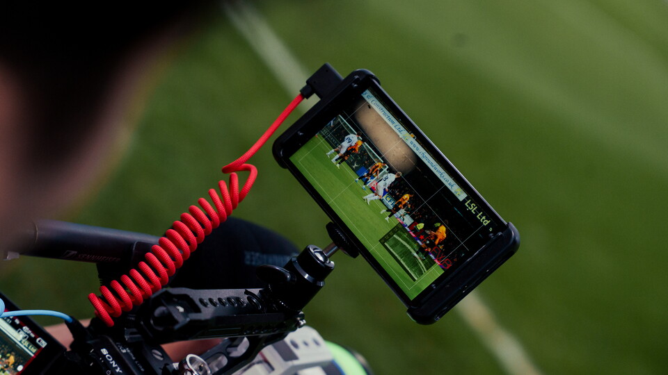 A close up of a camera filming a match