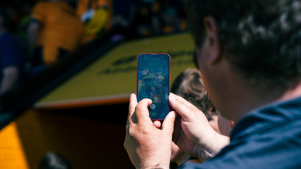 A fan taking a photo at the Cledara Abbey Stadium
