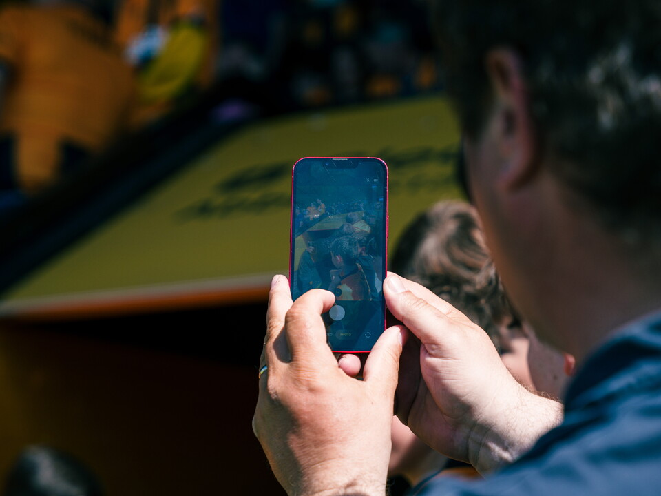 A fan taking a photo at the Cledara Abbey Stadium
